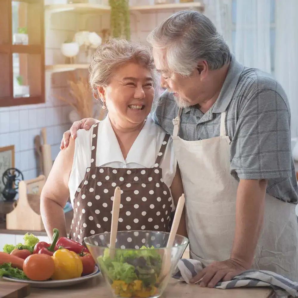 Senior Asian Couple Preparing Meal